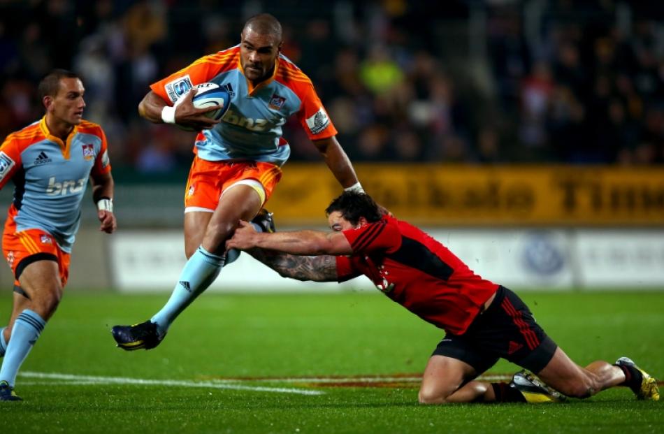 Patrick Osborne of the Chiefs is tackled by Zac Guildford of the Crusaders during the round 15...