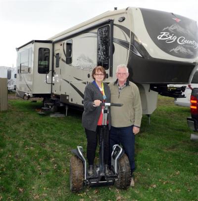 Pauline and Les Johnson with one of their  Segways outside their Big Country fifth-wheeler...