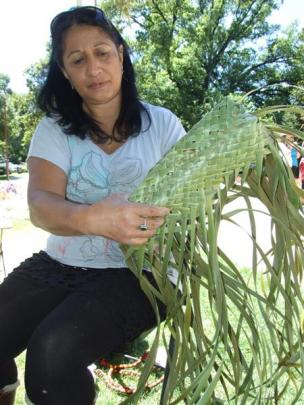 Pauline May, of Frankton, begins a raranga (weaving) demonstration to create a kete (basket)....