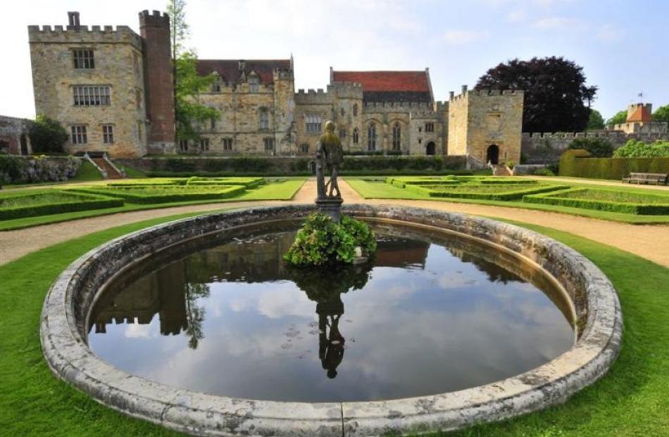 Penshurst Place and Gardens viewed from the Italian Garden, after the pond featuring a statue of...