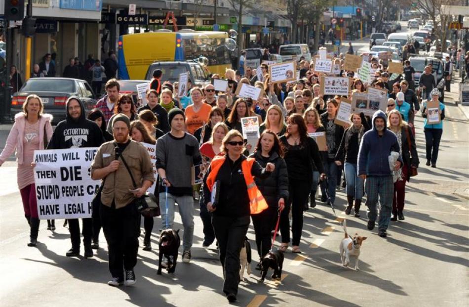 People and their pets march in George St, Dunedin, yesterday in protest against recreational...