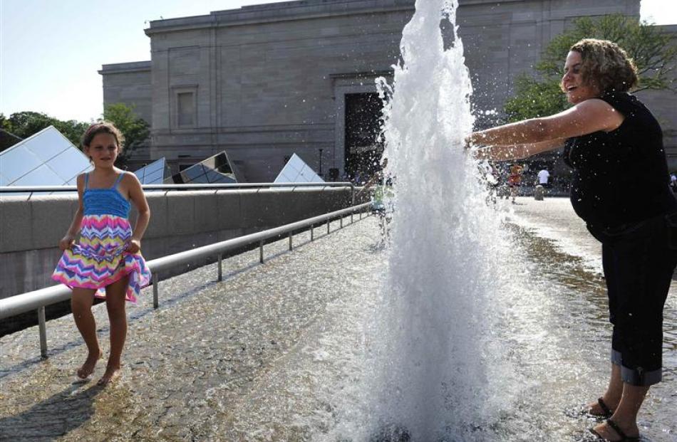 People cool themselves in oppressive heat in Washington DC. Photos by Reuters.