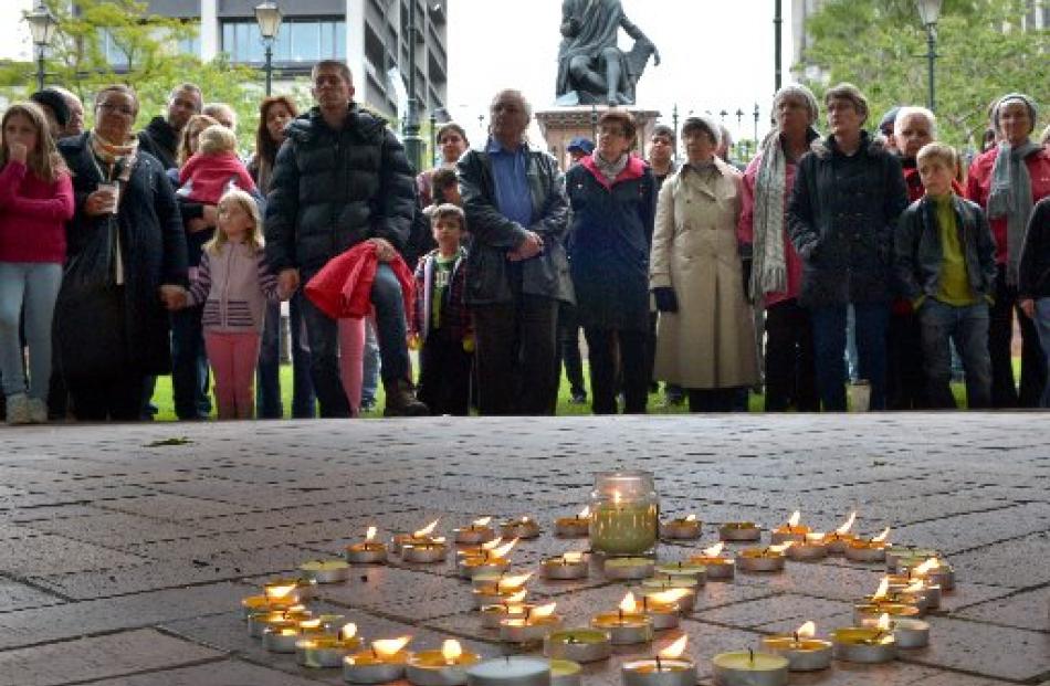 People gather in the Octagon in Dunedin yesterday to remember the victims of the terror attacks...