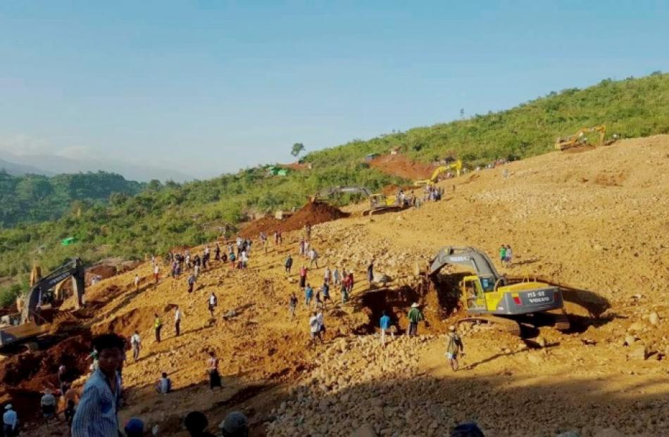 People look for bodies after the landslide in northern Myanmar. Photo: Reuters