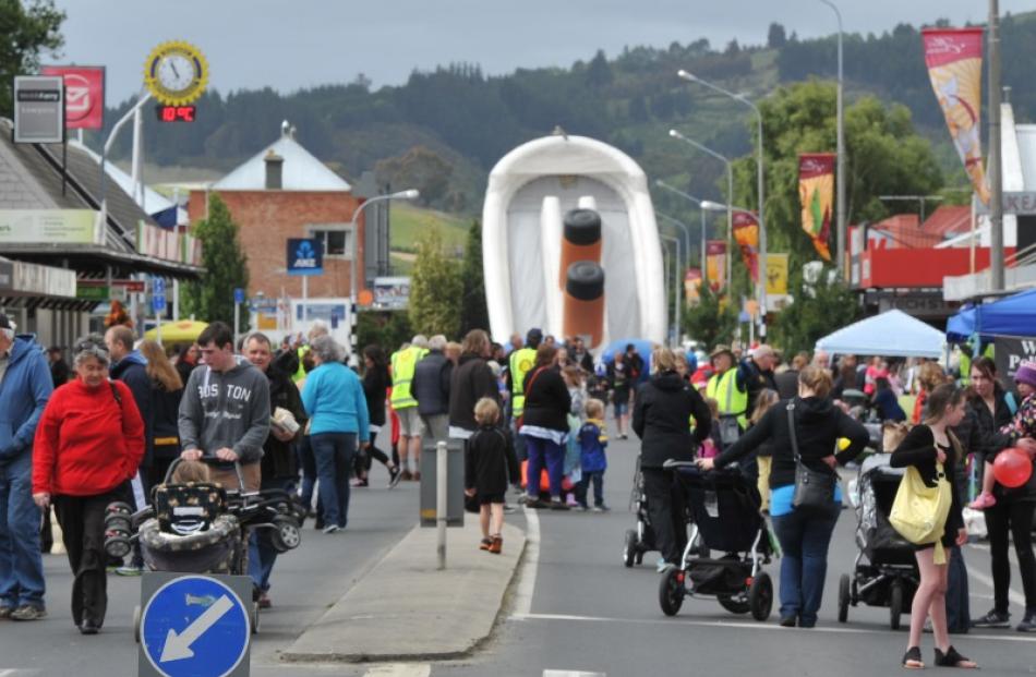 People walk up and down a closed-off Gordon Rd during last year's Mosgiel market day. During this...