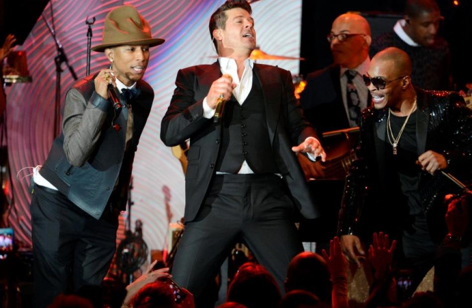 Performers (l-r) Pharrell Williams, Robin Thicke and T.I. on stage at an event in Beverly Hills,...