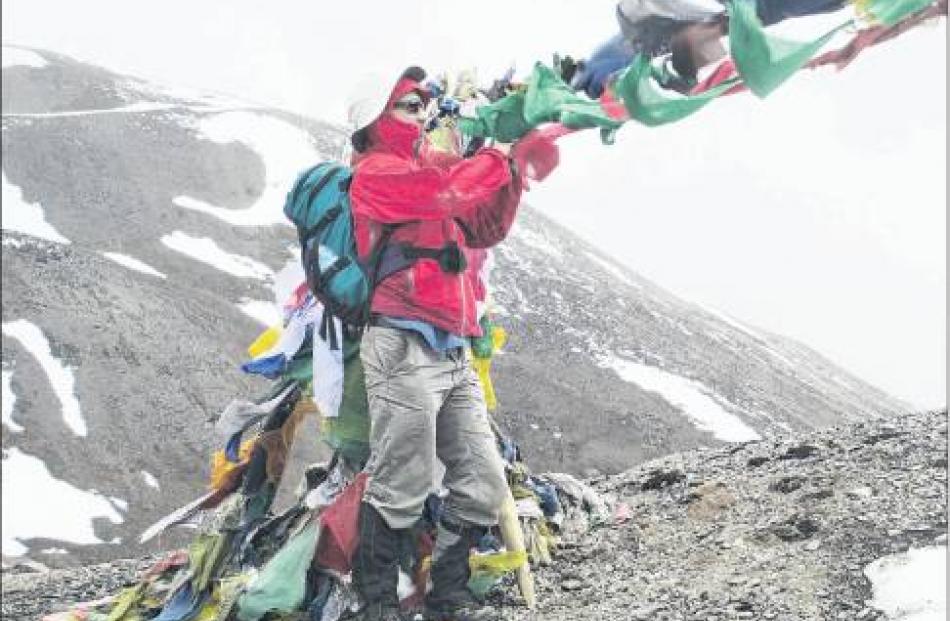 Philip Somerville adds his prayer flags at our highest pass (4800m). Photos Shona Somerville