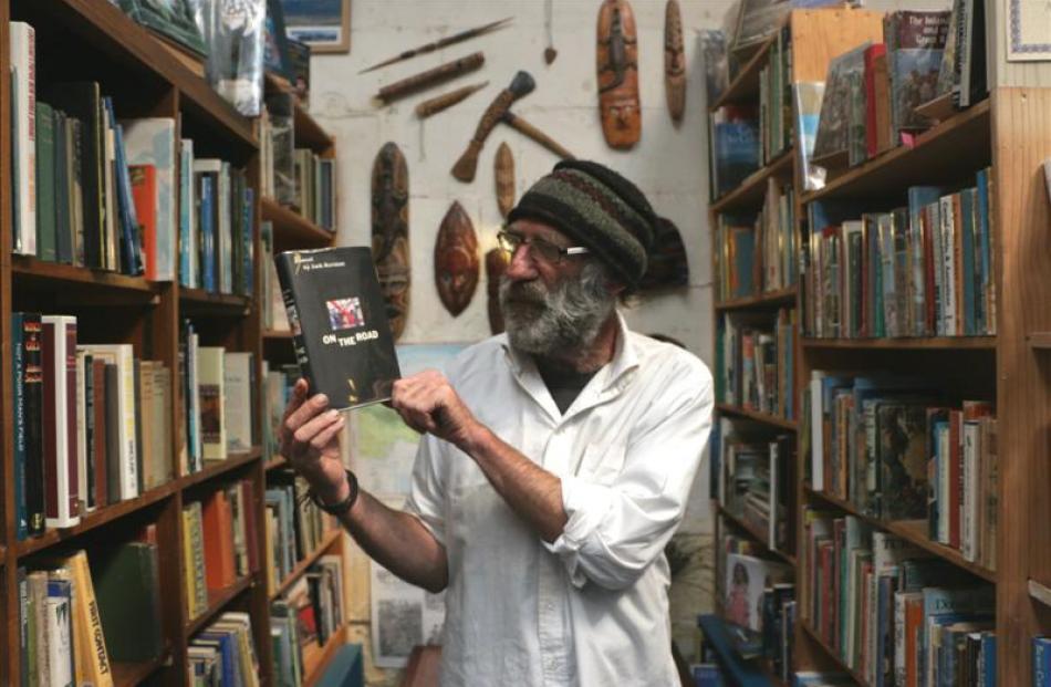 Poet David Merritt admires the first-edition copy of Jack Kerouac's novel On the Road at...