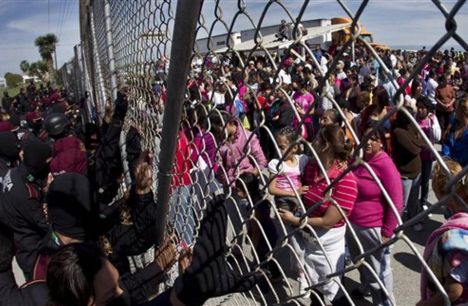 Police hold back the relatives of inmates outside the Apodaca correctional state facility on the...