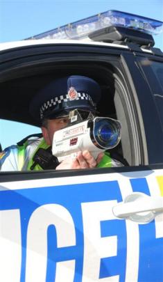 Police officers check on traffic and motorists' behaviour yesterday on the Southern Motorway....
