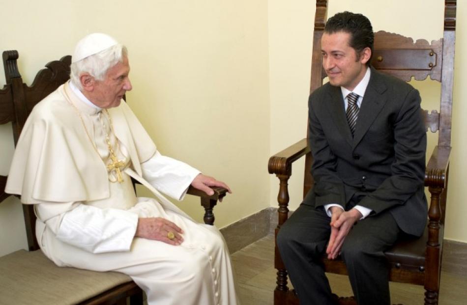 Pope Benedict XVI (L) talks with former butler Paolo Gabriele during a private audience at the...