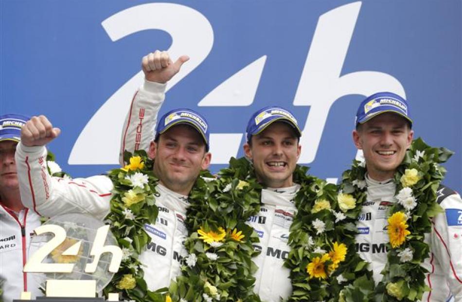 Porsche team members (L-R) Nick Tandy, Earl Bamber, and Nico Hulkenberg celebrate their victory...