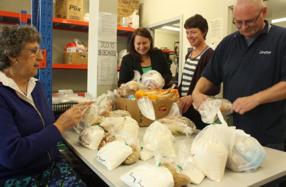 Preparing food parcels for the Salvation Army food bank are 
...