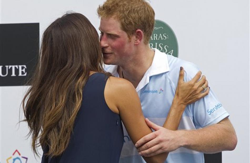 Prince Harry greets Brazilian model Fernanda Motta after a charity polo match in Campinas as part...