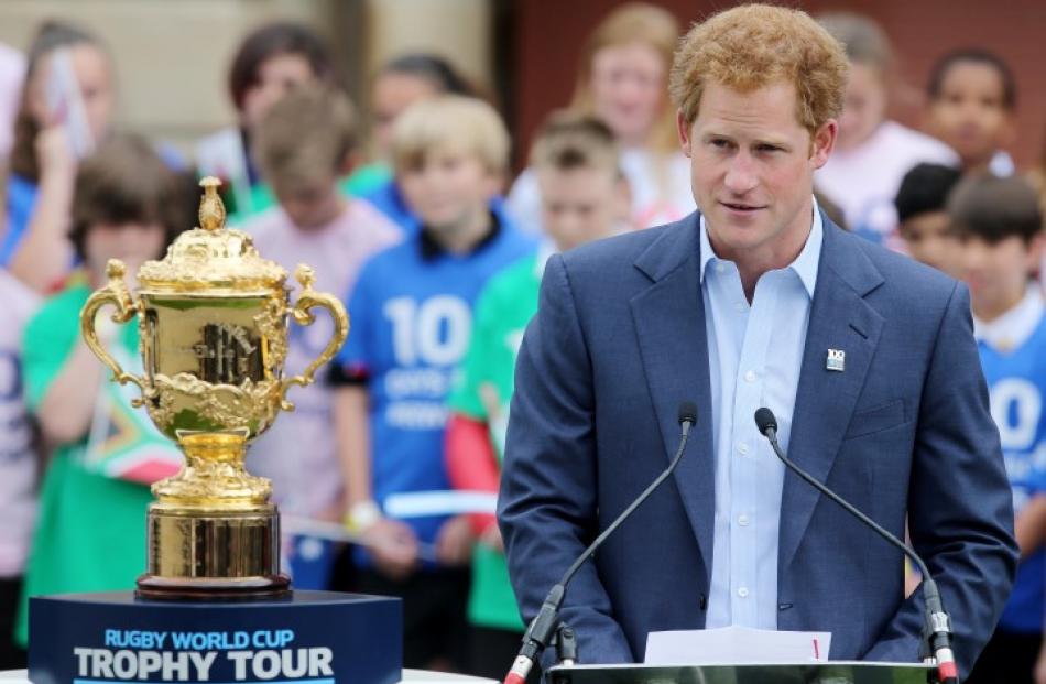 Prince Harry stands beside the Webb Ellis Trophy as he makes a speech at Twickenham to mark 100...