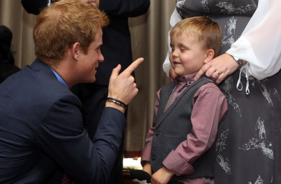 Prince Harry talks to 6-year-old Alex Logan as he attends the WellChild awards ceremony at the...