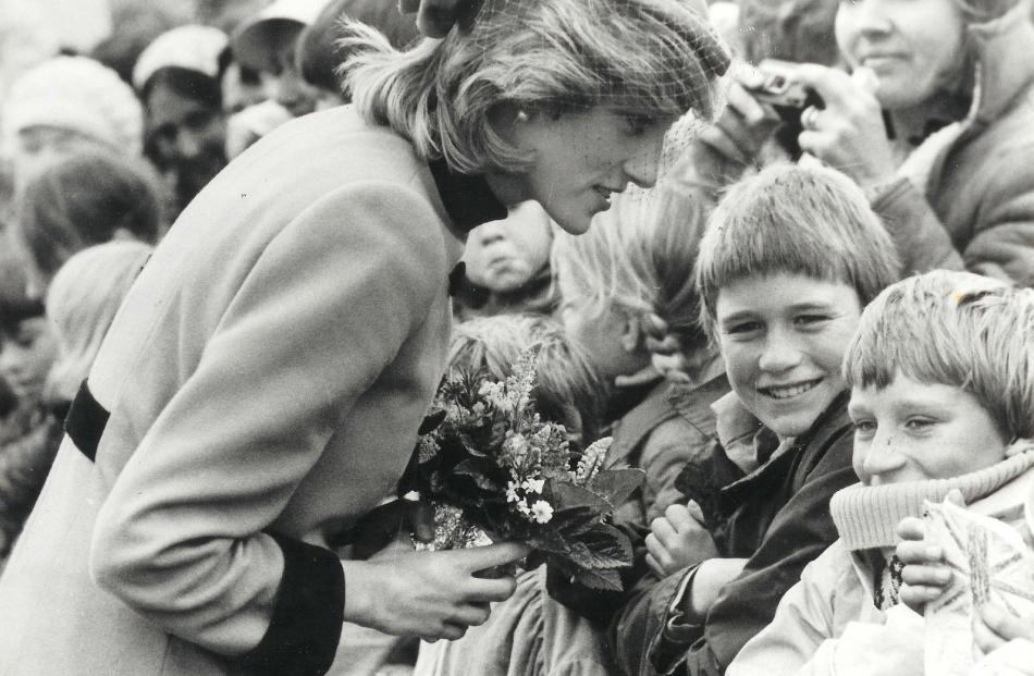 Princess Diana draws shy smiles from a couple of young fans in Dunedin in 1983. Jane Falconer is...