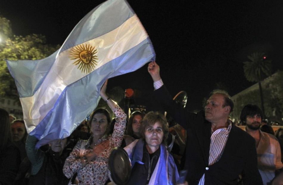 Protesters shout slogans against the Argentine President Cristina Fernandez de Kirchner in front...