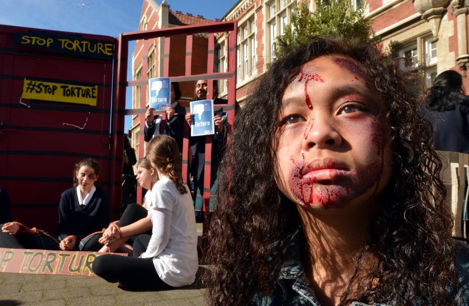 Otago Girls’ High School pupil Veronique Montalba (13) wears special effects make›up to protest...