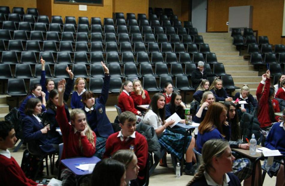 Pupils raise their hands to take part in the spot prize section of the quiz. Photos by Liam...