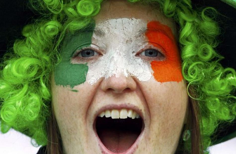 An Ireland supporter cheers before their Rugby World Cup quarter-final match against Wales at...