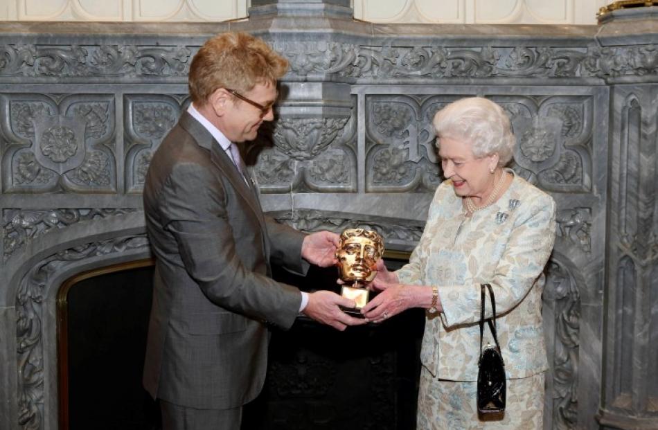 Queen Elizabeth receives an honorary BAFTA award from actor Kenneth Branagh, in recognition of a...