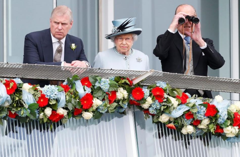 Queen Elizabeth watches the Epsom Derby with Prince Andrew (L) and Prince Philip, the Duke of...