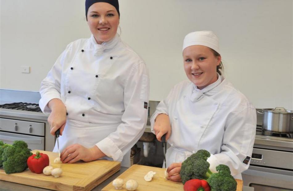 Queen's High School culinary arts pupils Lauren Wright (left) and Abby Johnson practise their...