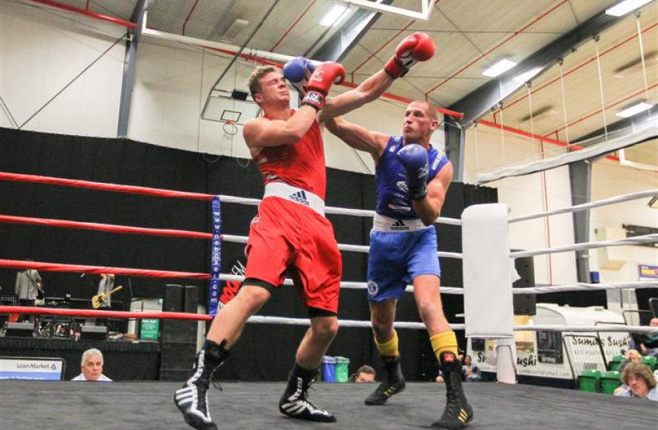 Queenstown light heavyweight Sam Connely (blue)  beats Sam Beck, of Dunedin. Photos by Blair...