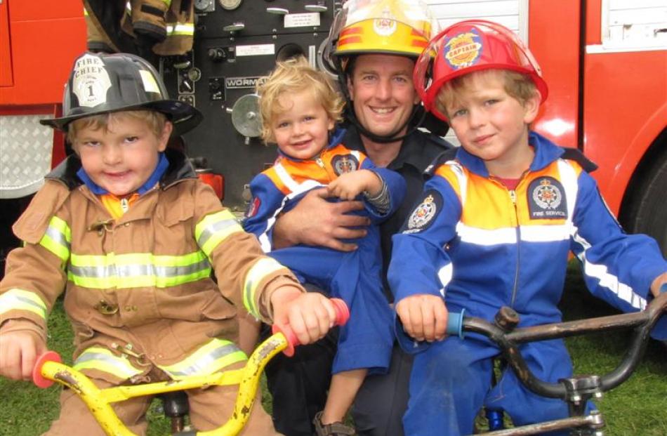 Queenstown Volunteer Fire Brigade firefighter Andrew Bary with sons George (10), William (4) and...