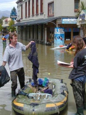 R and R Sport staff members Ian Bell and Sonya Tamblyn begin cleaning up outside the store after...