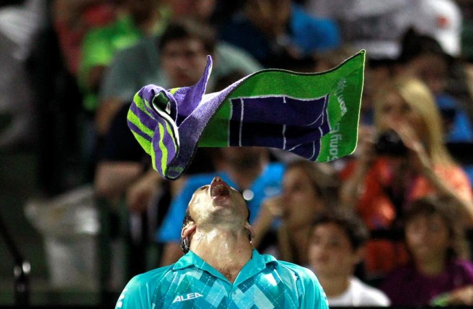 Radek Stepanek of the Czech Republic throws his towel over his head after losing a challenge to...