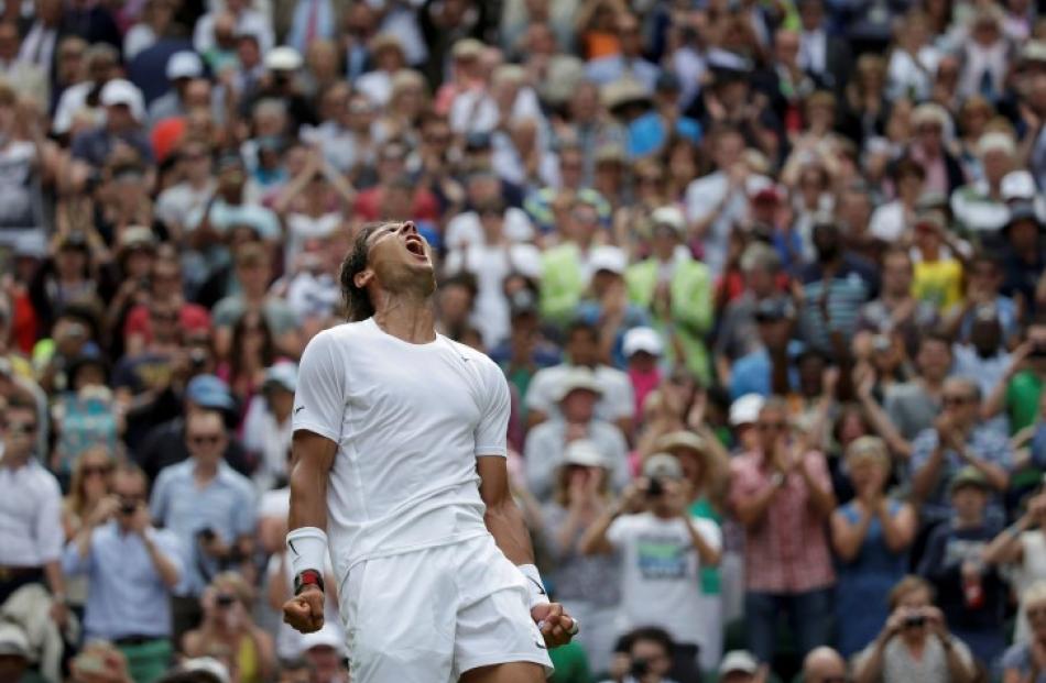 Rafael Nadal celebrates after defeating Lukas Rosol. REUTERS/Max Rossi
