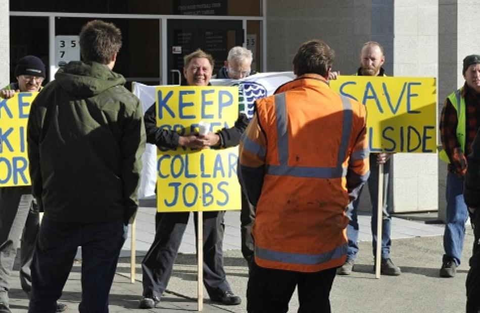 Rail and Maritime Transport Union national secretary Wayne Butson, centre, leads a picket line of...
