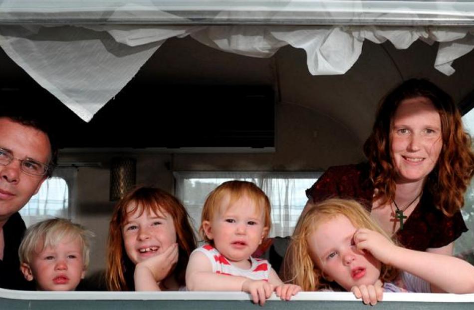 Recovering in their caravan in Dunedin yesterday after a windy night are the Richmond family ...