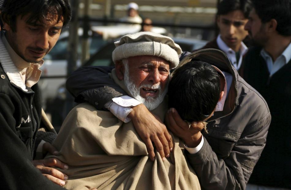 Relatives grieve their loss at the Hayatabad medical complex after a suicide bomber targeted a...