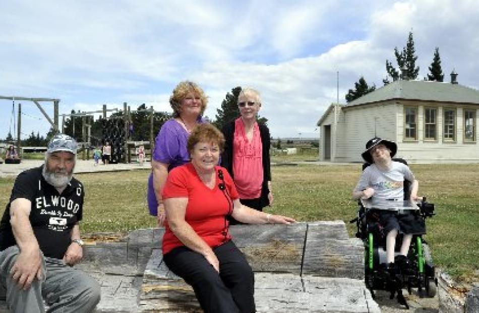 Relaxing at Camp Sutton  on Friday are (from left) Dunedin  holidaymakers John Fitzwilliam,...