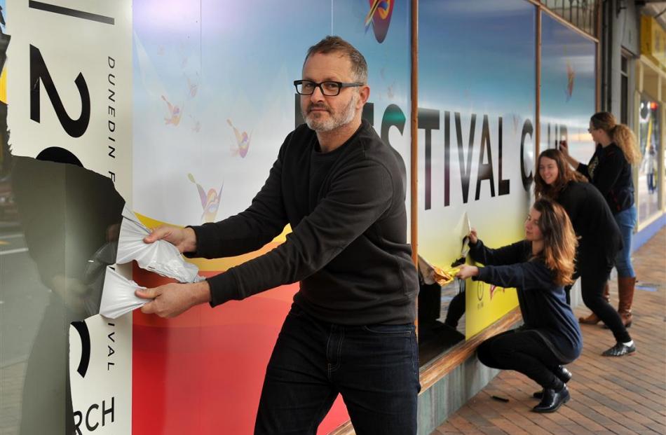 Removing signs from the front of the Festival Club in George St yesterday  are (from left)...