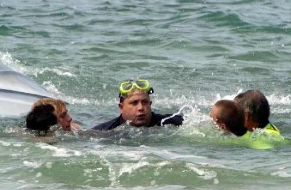 Brighton Surf Life Saving Club and Water Rescue squad members surround Shane Hale. Photo by...