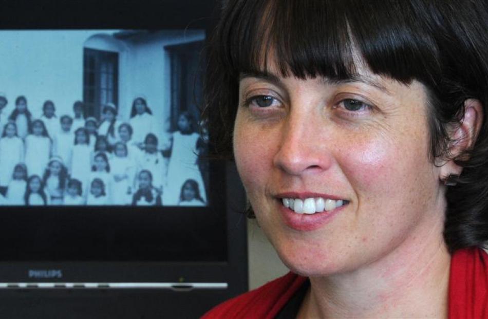 Researcher Jane McCabe reflects on a photograph depicting her grandmother, Lorna Peters (standing...