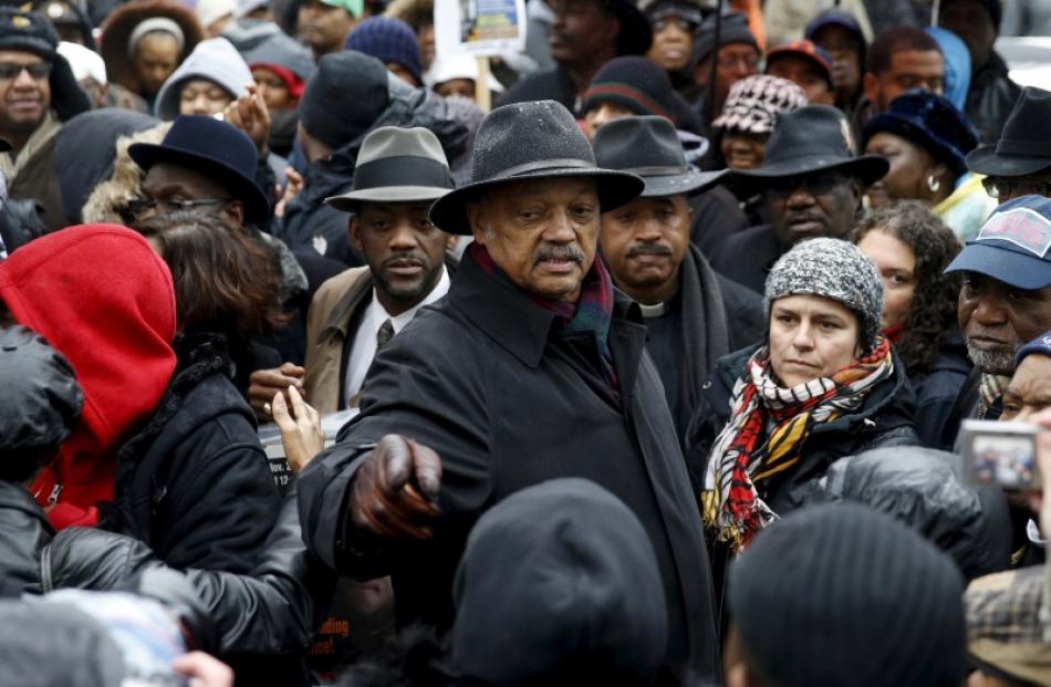 Rev. Jesse Jackson (C) joins demonstrators during a protest intending to disrupt Black Friday...