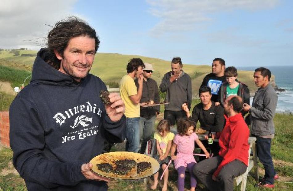 Rhyse Bartlett savours a paua fritter while other members of Paua to the People and their...