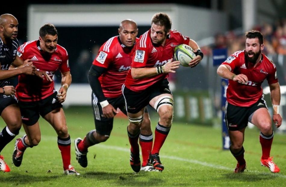 Richie McCaw (centre) of the Crusaders makes a break during the Super Ruby Semi Final match...