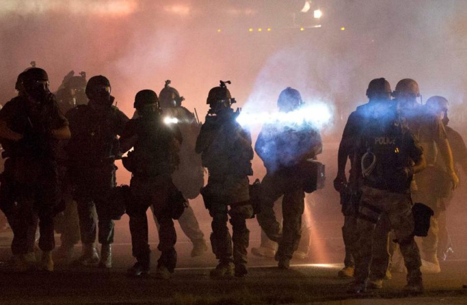 Riot police clear demonstrators from a street in Ferguson, Missouri. REUTERS/Mario Anzuoni