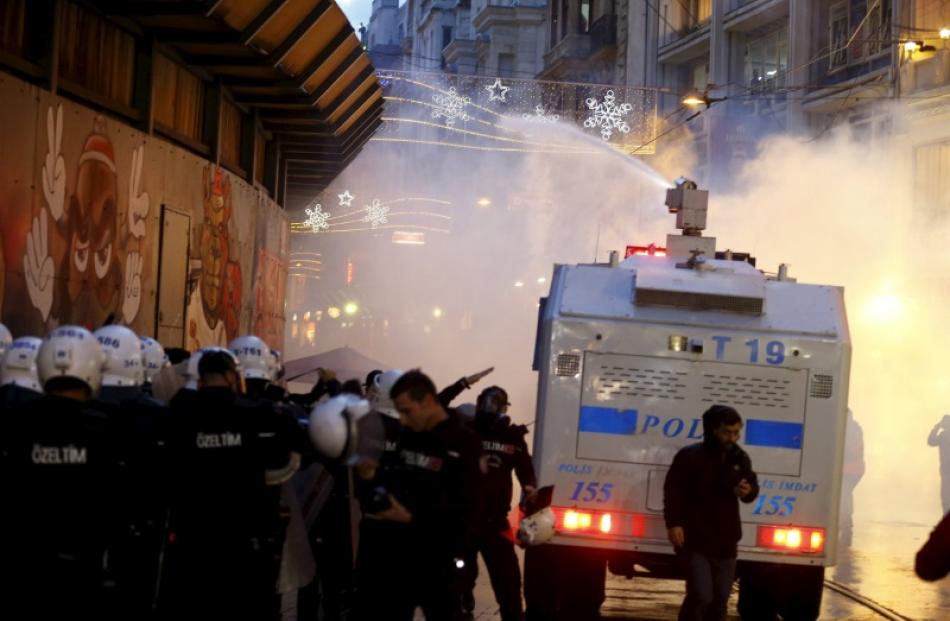 Riot police use a water cannon to disperse demonstrators during a protest in Istanbul, Turkey....