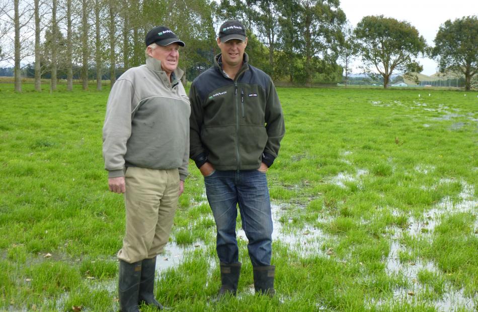 Robin Murphy (left) and son Bruce, who share in the running of the family dairy farming business ...