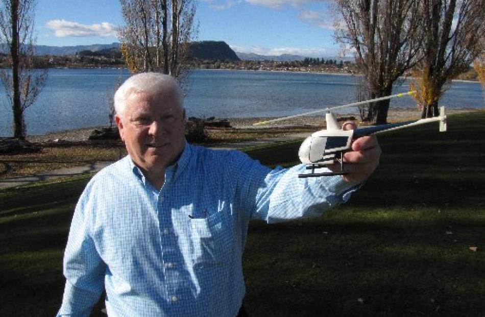 Robinson Helicopters safety instructor Tim Tucker, of the US, with a model helicopter at pilot...