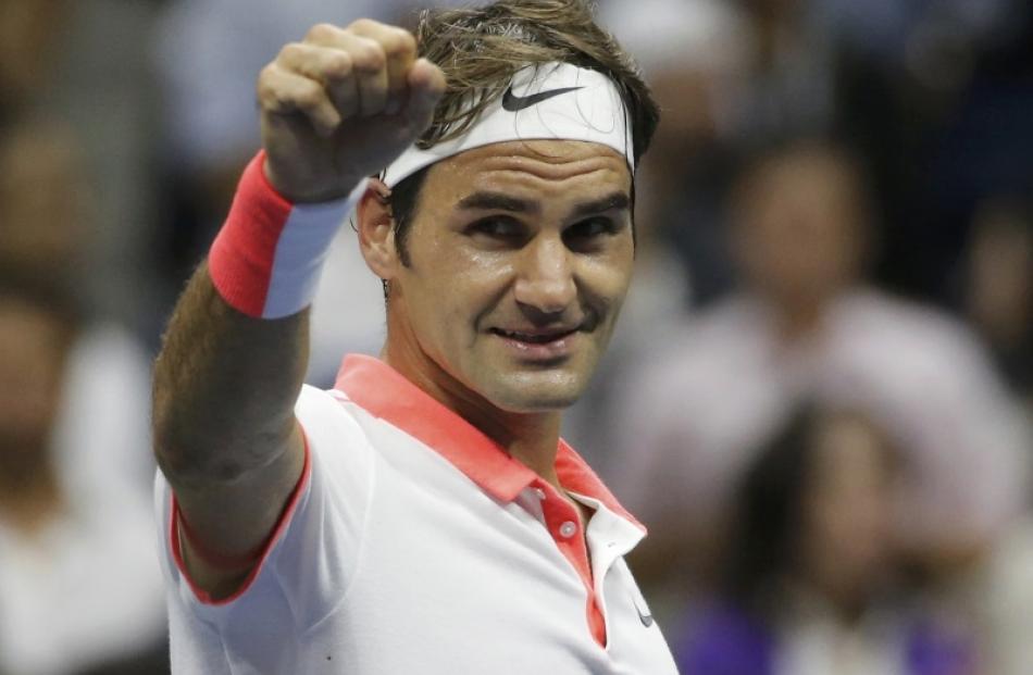 Roger Federer of Switzerland celebrates after defeating compatriot Stan Wawrinka in their men's...