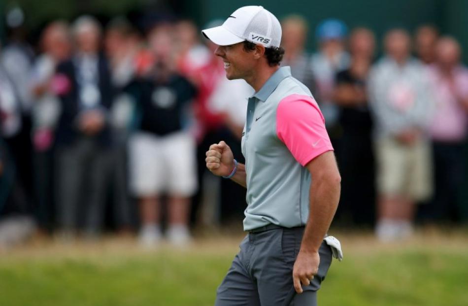 Rory McIlroy celebrates on the 18th green after winning the British Open at the Royal Liverpool...