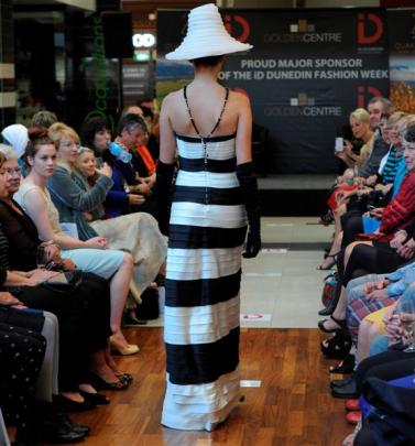 Rosie Whiting, of Dunedin, models a BCBG Max Azria gown and Stephen Jones hat.